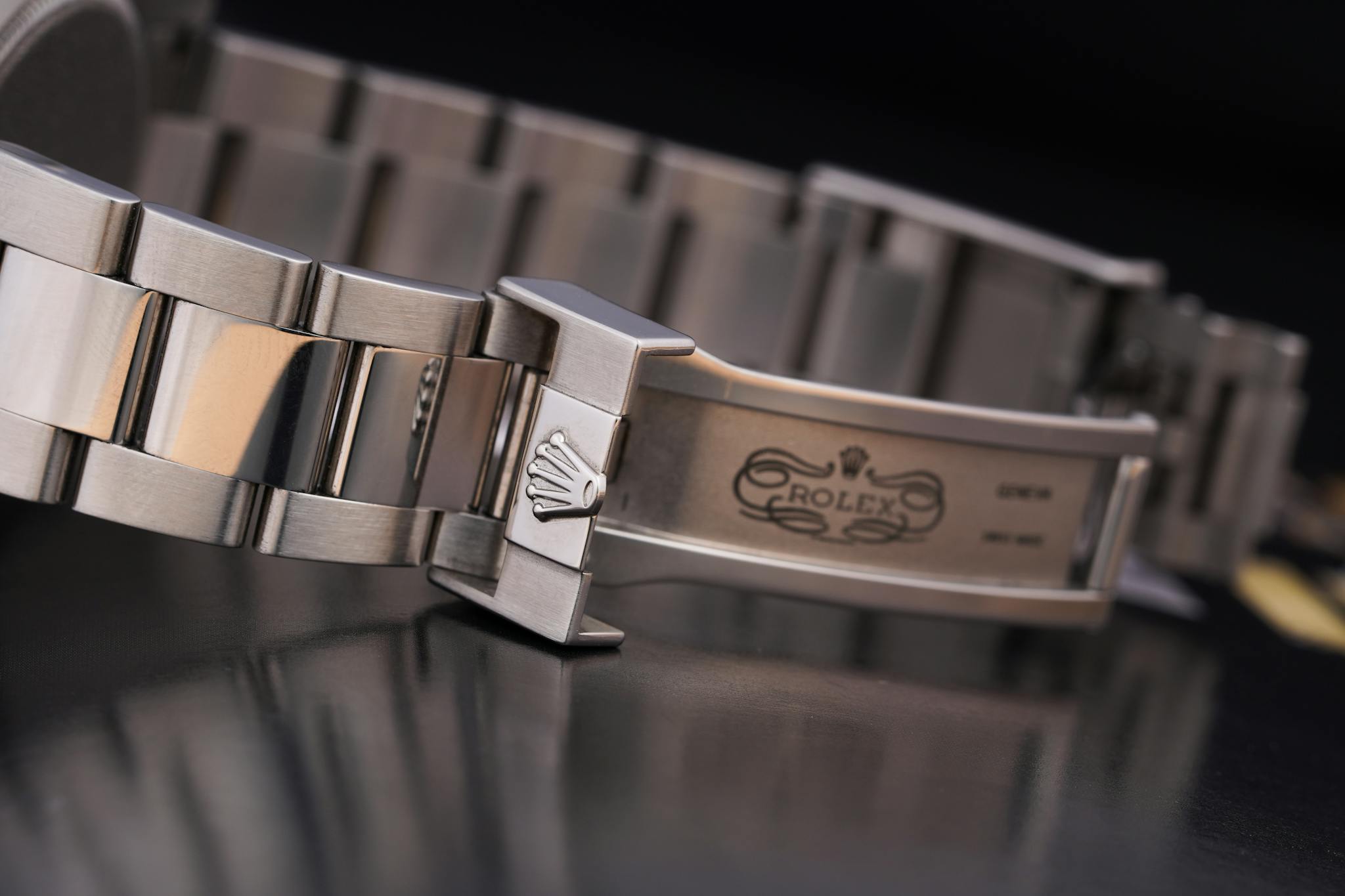Close-up of a luxury silver watch bracelet showcasing intricate design details.