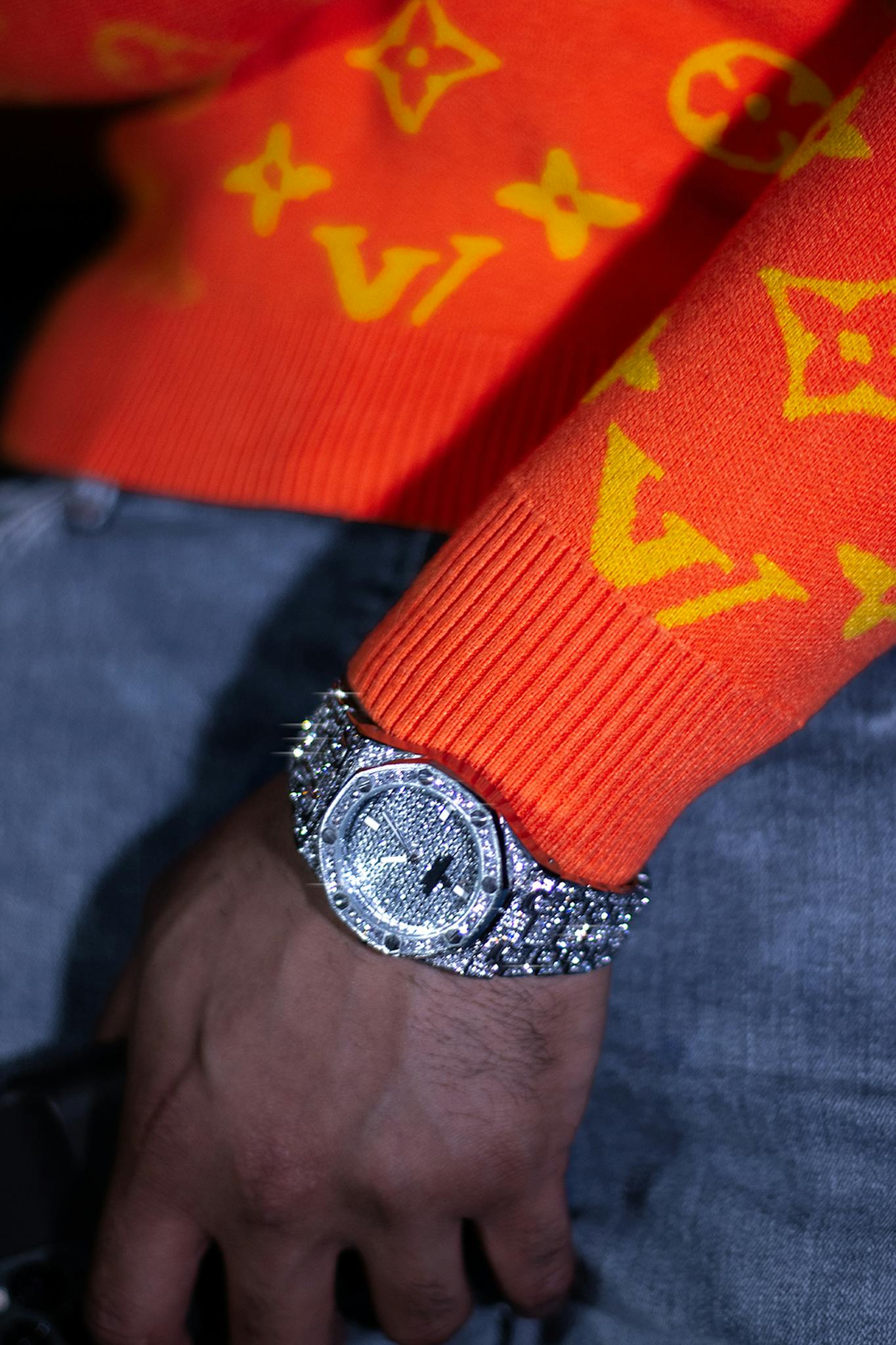 Close-up of a shining diamond encrusted wristwatch showcasing luxury fashion style.